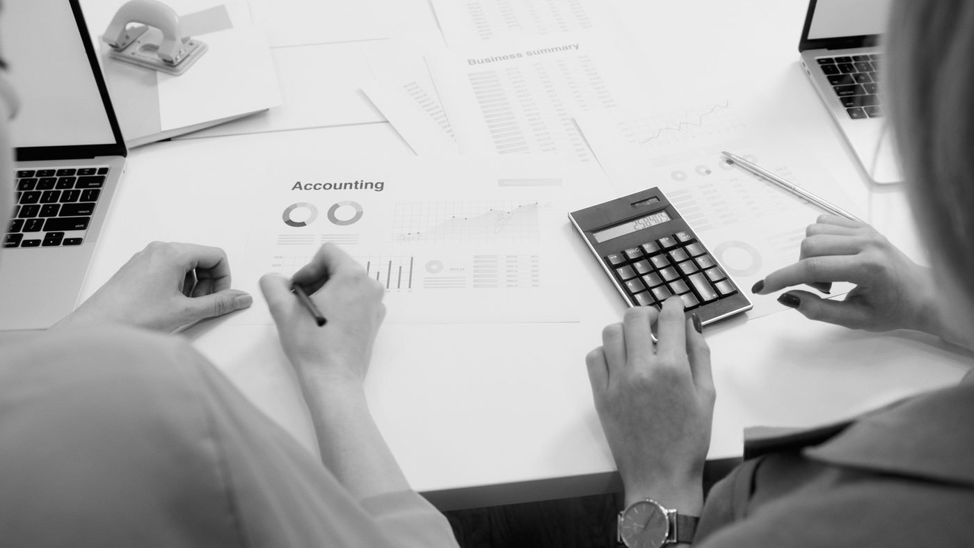 Close-up of accounting paperwork, calculator and laptop